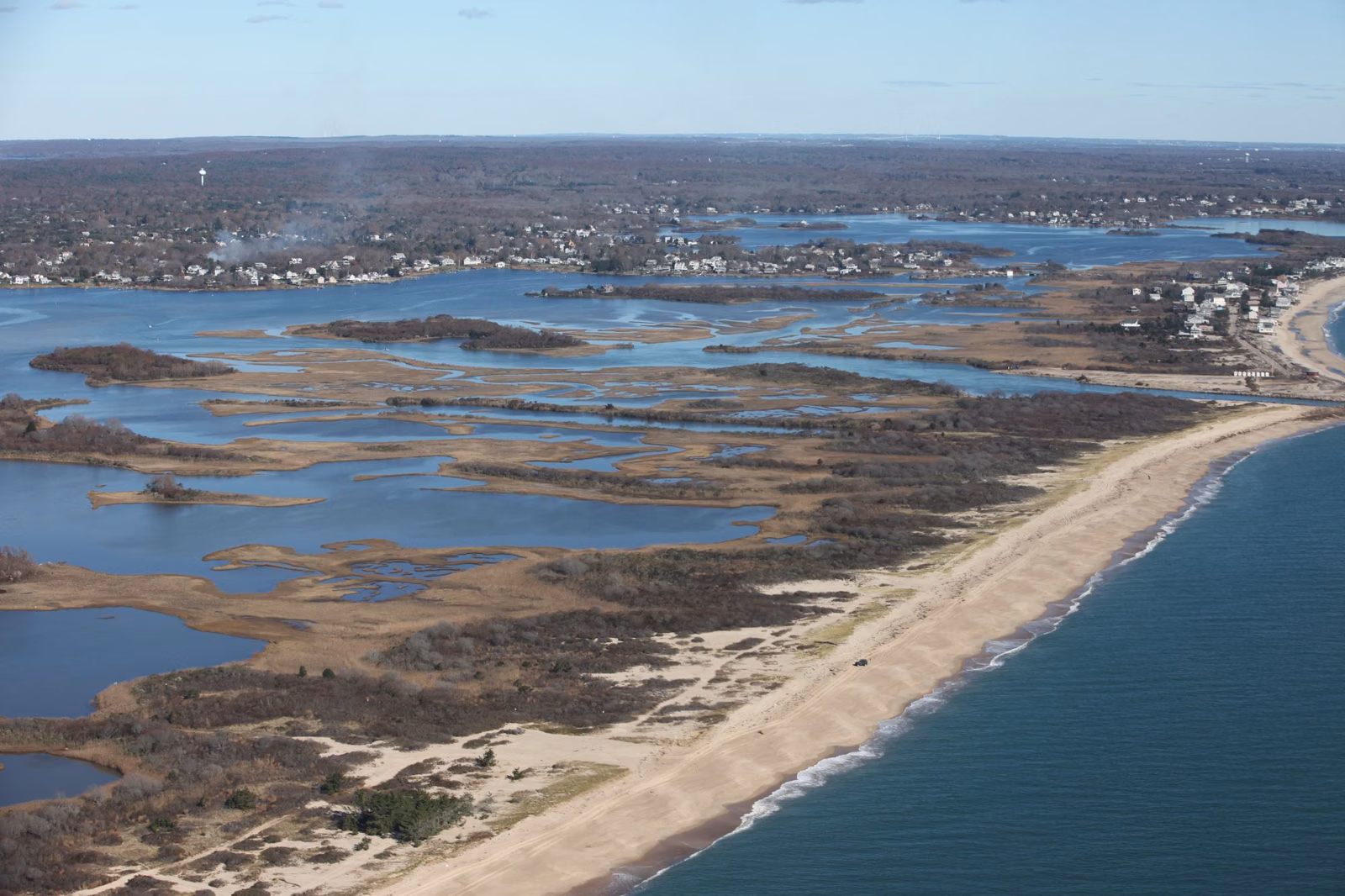 Aerial view of a long barrier beach and salt pond on the Charlestown, Rhode Island coast