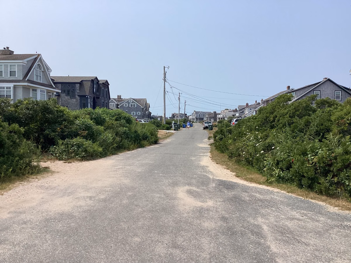 Sandy lane between shingled summer houses in Quonochontaug, Charlestown